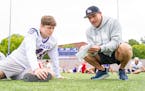 Northwestern tight end Nolan Howle listens to coaching from Boomer Roepke, the offensive coordinator for the University of Northwestern-St. Paul.