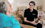 Geek Squad agent Michael Duvall educates Margaret, 89, of Moosic, Pa., about a wearable device that monitors vital signs. 