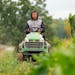 Kue Lor cuts tall weeds with a lawn mower Wednesday, Sep. 06, 2023, on the family’s farm in Nerstrand, Minn. ] ALEX KORMANN • alex.kormann@startri