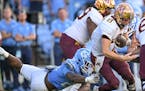 Gophers quarterback Athan Kaliakmanis bobbled the ball under pressure from North Carolina linebacker Kaimon Rucker during the second half Saturday