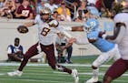 Gophers quarterback Athan Kaliakmanis (8) was pulled down by North Carolina defensive lineman Jacolbe Cowan during the second half Saturday in Chapel 
