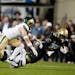 Colorado two-way star Travis Hunter (12) was dragged down after a short gain by Colorado State defensive back Henry Blackburn, back left, and defensiv