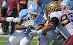 North Carolina running back Omarion Hampton (28) runs the ball for a touchdown as Minnesota defensive lineman Kyler Baugh (93) closes in during the se