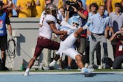 North Carolina defensive back Alijah Huzzie (28) breaks up a pass intended for Minnesota wide receiver Daniel Jackson (9) on Saturday.