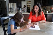 Aggie Gambino, right, helped her 10-year-old daughter, Giada, work on math worksheets at the dining room table in their home in Spring, Texas.