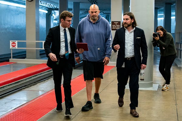 U.S. Sen. John Fetterman, D-Pa., wears a sweatshirt and baggy shorts while speaking with reporters ahead of a Senate vote on Capitol Hill on June 1. F