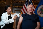Gov. Tim Walz received a flu shot Tuesday from nurse KaLee Medina at the State Capitol in St. Paul.