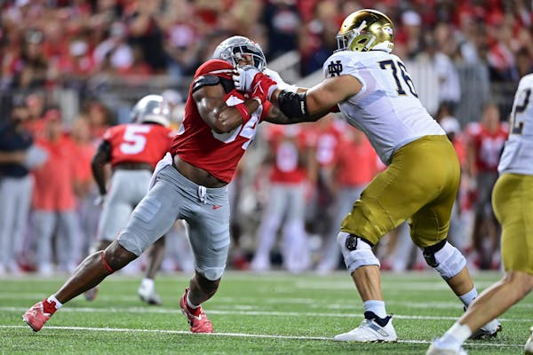 Joe Alt, right, a Notre Dame tackle from Totino Grace, blocked Ohio State’s Tyler Friday when the teams met Sept. 3, 2022 in Columbus, Ohio, a 21-10