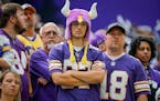 Minnesota Vikings fans stand quietly late in the second half of an NFL football game against the Tampa Bay Buccaneers, Sunday, Sept. 10, 2023, in Minn