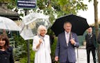 Britain’s King Charles III and Queen Camilla pose at a plaque named after his late mother, Queen Elizabeth II at the Flower Market Thursday, Sept. 2