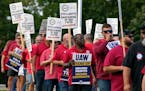 United Auto Workers members march outside the Stellantis North American Headquarters on Sept. 20 in Auburn Hills, Mich.