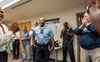 Charlie Adams, the Minneapolis Police Department Fourth Precinct Inspector, reacts as he arrives for a surprise party in his honor Thursday, Sept. 21,
