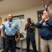 Charlie Adams, the Minneapolis Police Department Fourth Precinct Inspector, reacts as he arrives for a surprise party in his honor Thursday, Sept. 21,