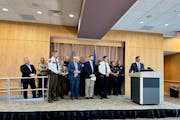 Minnesota Chiefs of Police Association Executive Director Jeff Potts, farthest right, along with several local law enforcement agency heads, held a ne