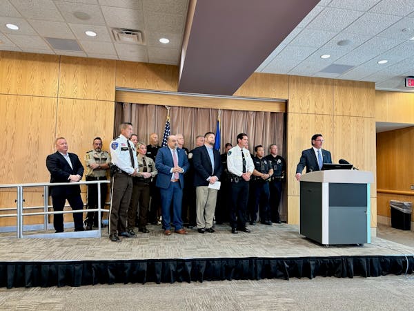 Minnesota Chiefs of Police Association Executive Director Jeff Potts, farthest right, along with several local law enforcement agency heads, held a ne