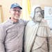 Bud Heckman, friend of the Abdelkader Education Project, shows off the Emir Abdelkader monument after delivering it to Elkader City Hall from New York
