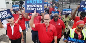 UAW President Shawn Fain marches with union members during a practice picket outside the Stellantis Detroit Assembly Complex in Detroit on Aug. 22, 20