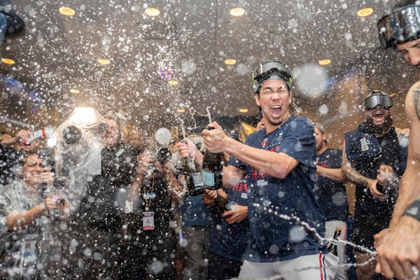 Twins pitcher Kenta Maeda and other members of the organization celebrated with champagne in the clubhouse after clinching the American League Central