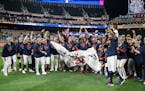 Twins players and staff celebrate after winning the American League Central title at Target Field.