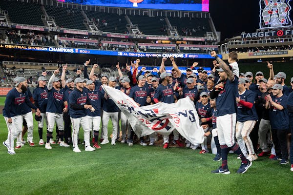 Twins players and staff celebrate after winning the American League Central title at Target Field.