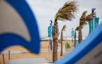 The tops of trees blow sideways at the Virginia Beach, Virginia Oceanfront on Friday, Sept. 22, 2023 as Tropical Storm Ophelia approaches the area.