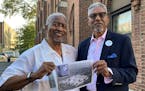 Chester Deanes, left, and Ben Phillips hold a photo of the former Pruitt-Igoe housing development in St. Louis, where they lived growing up on Sept. 7