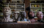 Busts of Neanderthal and hominins line a table at the studio of paleoartist John Gurche in Trumansburg, N.Y., Wednesday, May 31, 2023.