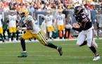 Green Bay Packers running back Aaron Jones heads for the end zone for a touchdown as Chicago Bears linebacker T.J. Edwards pursues during the second h