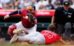Minnesota Twins catcher Christian Vazquez catches a pass to tag out Los Angeles Angels’ Nolan Schanuel during the eighth inning of a baseball game, 