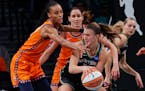 Liberty guard Sabrina Ionescu, front right, is defended by Sun forward DeWanna Bonner on Sunday.