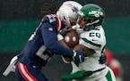  Jets running back Breece Hall (20) was tackled by the Patriots during the third quarter Sunday.