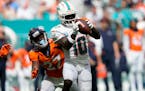 Dolphins receiver Tyreek Hill (10) caught a pass over Broncos cornerback Damarri Mathis (27) during the second half Sunday.