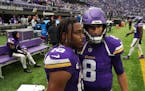 Minnesota Vikings quarterback Kirk Cousins (8) talks with wide receiver Justin Jefferson (18) on the field following an NFL game between the Minnesota