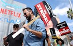 Striking Writers Guild of America members picket with striking SAG-AFTRA members outside Netflix studios on Sept. 18, 2023 in Los Angeles. 