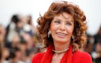 FILE - Italian actress Sophia Loren smiles during a photo call for “Human Voice,” (Voce Umana) at the 67th international film festival, Cannes, so