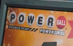 FILE - A display panel advertises tickets for a Powerball drawing at a convenience store, Nov. 7, 2022, in Renfrew, Pa. The ninth-largest lottery jack