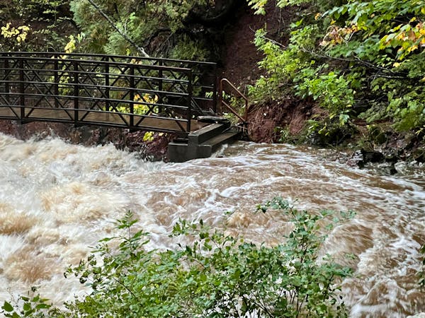 Water reached the upper steps of a bridge over Tischer Creek between E. Fourth St. and Superior St. in Duluth on Sunday night.