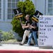 Picketers carry signs outside Amazon Studios in Culver City, Calif. on Monday, July 17, 2023.