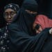Sundus Adan Odhowa, left, comforts Sundus Mohamoud Ali(red) as they speak at a press conference calling for an independent investigation of a crash th