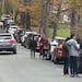 People and cars line a narrow road outside a private property in an undated photo, in Pomfret, Vt., that has become a destination for fall foliage vie