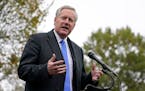 White House chief of staff Mark Meadows speaks with reporters outside the White House, Monday, Oct. 26, 2020, in Washington. Cassidy Hutchinson, a for