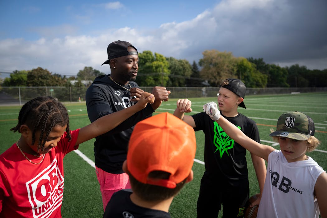 Cleveland McCoy spoke to his students at “quarterback school” last weekend in Osseo.