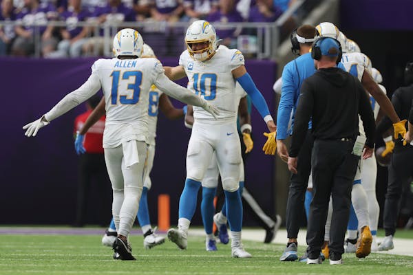 Los Angeles Chargers quarterback Justin Herbert (10) celebrates with wide receiver Keenan Allen (13) after Allen threw a touchdown pass against the Vi