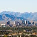 Downtown Phoenix skyline with the South and Sierra Estrella mountain ranges in the background. 