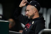 Minnesota Twins manager Rocco Baldelli sits in the dugout during the first inning of a baseball game against the Chicago White Sox, Friday, Sept. 15, 