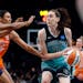 The New York Liberty’s Breanna Stewart (30) controls the ball as the Connecticut Sun’s Tiffany Hayes (15) and Olivia Nelson-Ododa (10) defend in t
