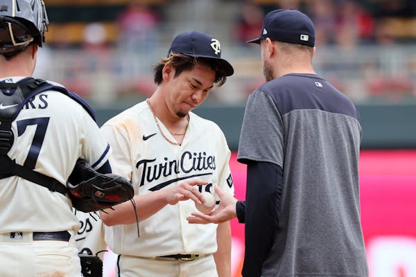 Twins pitcher Kenta Maeda hands the ball to manager Rocco Baldelli before leaving in the eighth inning on Thursday.
