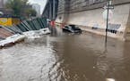 In this image taken from video, a car sits stranded in flood waters at the base of the Williamsburg Bridge, Friday, Sept. 29, 2023, in New York. A pot