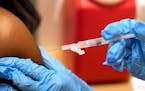 CVS pharmacist Kim Nguyen administered a Moderna Spikevax COVID-19 vaccine Sept. 20, 2023, in Cypress, Texas. 