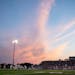 Pink clouds fill the sky in the second quarter of Lakeville North’s game against Lakeville South Friday, Sep. 15, 2023, at Lakeville North High Scho